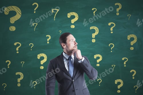 Preview: Portrait Of Attractive Thoughtful Young European Businessman On Chalkboard Wall Background With