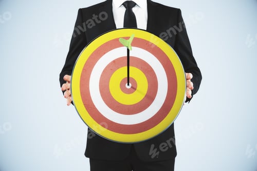 Preview: Man Holding A Dart Board With A Direct Hit On Target