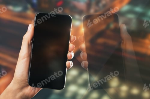 Preview: Hand Holding Empty Black Smartphone With Reflection On Blurry Night City Background. Mock Up