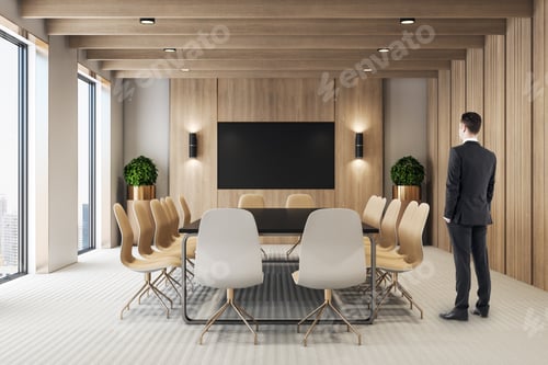Preview: Businessman Standing In Modern Meeting Room Interior With Empty Tv Screen. Presentation And