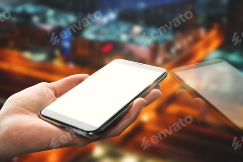 Preview: Hand Holding Empty White Mobile Phone With Reflection On Blurry Night City Background. Mock Up