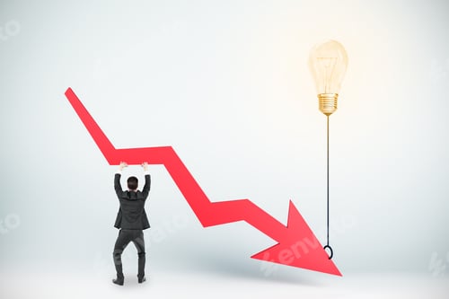 Preview: Businessman Holding Abstract Downward Arrow Attached To Glowing Lamp Balloon. Economy And Decrease