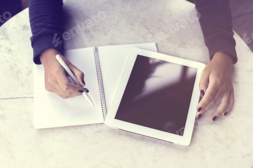 Preview: Girl Writes In A Notebook And Working With Digital Tablet