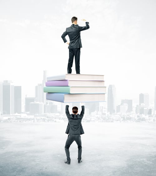 Preview: Businessmen Holding And Standing On Book Stack. City Background. Education And Teamwork Concept