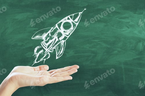 Preview: Hand Holding Creative Rocket Sketch On Concrete Wall Background. Startup And Begin Concept