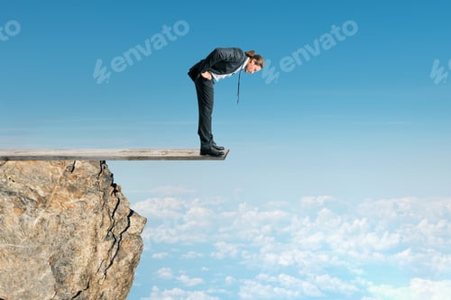 Preview: Businessman Looking Down From Mountain Top On Sky Background. Success And Altitude Concept