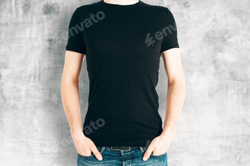Preview: Front View Of Casual Male In Blank Black Shirt On Concrete Background. Retail Concept. Mock Up