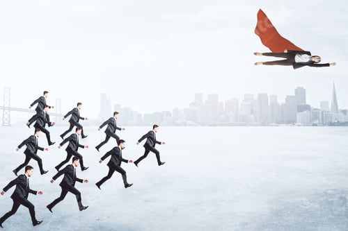 Preview: Row Of Businessmen Following Flying Businesswoman Hero With Red Cape On Blurry City Background