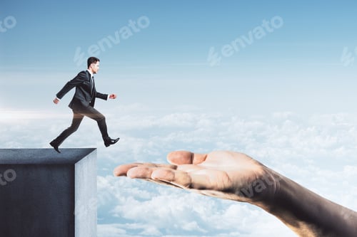 Preview: Businessman In Suit Jumping From Roof To Hand On Blue Sky Background. Leadership And Success Concept
