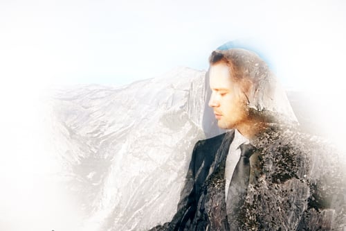 Preview: Side View Of Thoughtful Young Businessman On Abstract Landscape Background With Copy Space. Double