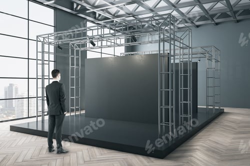 Preview: Businessman Standing In Gallery Interior With Black Exhibition Stand With Lighting Metal