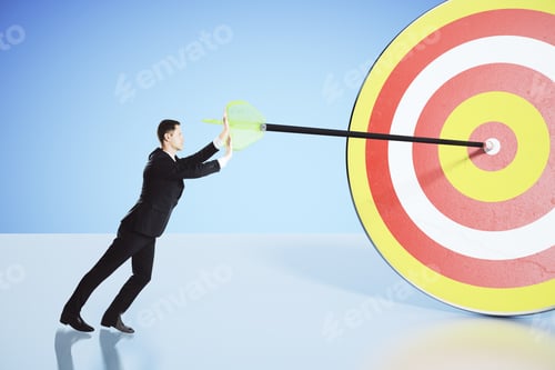 Preview: Move Towards Your Goal Concept With Businessman Pushing An Arrow Into The Bullseye