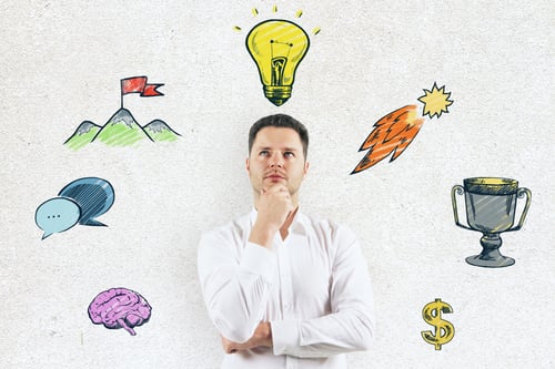 Preview: Handsome Caucasian Businessman Standing On Concrete Wall Background With Creative Lamp And Business