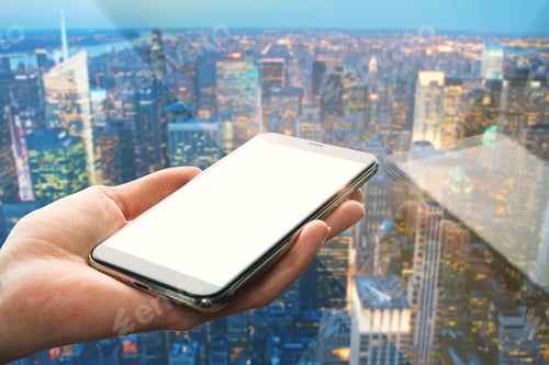 Preview: Hand Holding Empty White Cellphone With Reflection On Blurry Night City Background. Mock Up