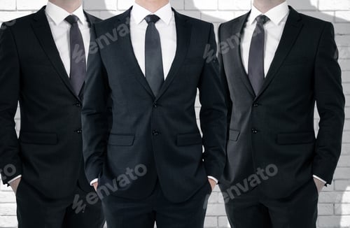 Preview: Three Unrecognizable Businessmen On White Brick Wall Background. Partnership Concept