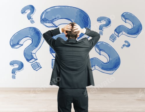 Preview: Back View Of Stressed Young Businessman Looking At Concrete Wall With Drawn Question Marks In