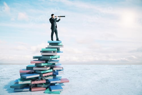 Preview: Career Growth And Development Concept With Businessman On Book Mountain Looking Through A Telescope.