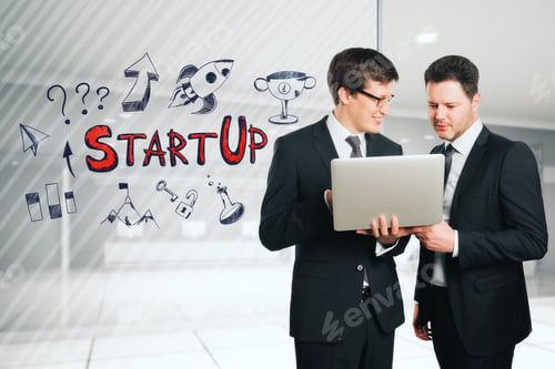 Preview: Two Handsome Happy European Usinessmen Using Laptop In Creative Office Interior With Start Up