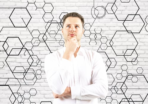 Preview: Portrait Of Thoughtful Young Businessman On Brick Background With Honeycomb Pattern