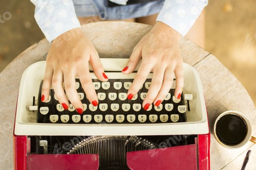Preview: Girl Typing On The Old Typewriter With A Cup Of Coffee Outdoors