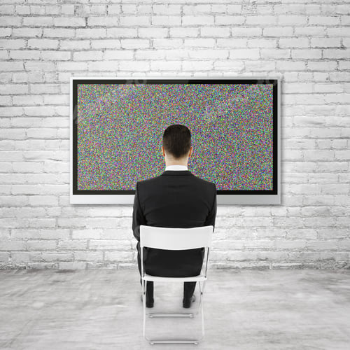 Preview: Businessman Sitting And Looking To Plasma On Brick Wall