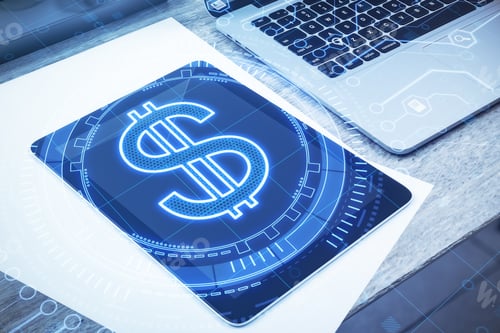 Preview: Close Up Of Creative Glowing Dollar Sign And Tablet On Office Desktop Background With Hologram