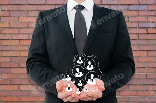 Preview: Businessman Holding Drawn Hr Icons On Red Brick Wall Background. Recruiting Concept