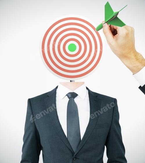 Preview: Hand With Green Dart Aiming At Target-Headed Businessman On Light Background. Aiming And Targeting
