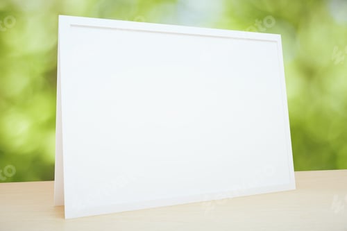 Preview: Blank Picture Frame On The Table At Foliage Background, Mock Up
