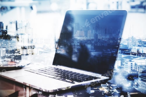 Preview: Close Up Of Empty Laptop Computer At Abstract Workplace With City View. Mock Up, Double Exposure