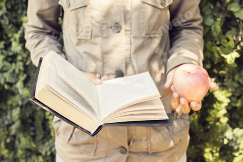 Preview: Girl Reading A Book And Carrying An Apple