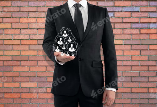 Preview: Businessman Holding Drawn Hr Icons On Red Brick Wall Background. Human Resources Concept