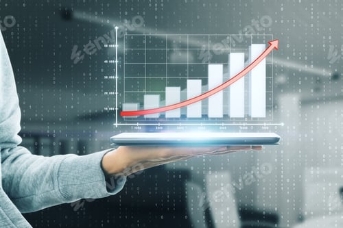 Preview: Close Up Of Hand Using Tablet With Business Chart Hologram On Blurry Office Interior Background