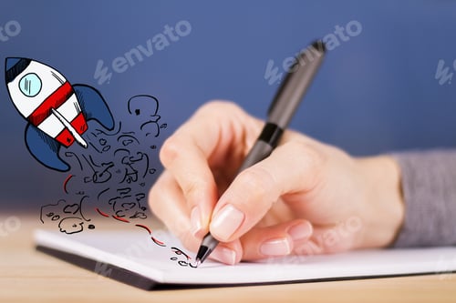 Preview: Female Hand Drawing Abstract Launching Spaceship In Notepad. Start Up Concept