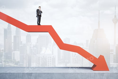 Preview: Attractive Tiny European Businessman Standing And Balancing On Abstract Red Downward Chart Arrow On
