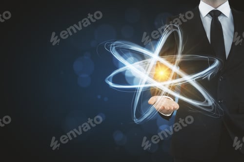Preview: Businessman Holding Creative Atom On Blurry Dark Backdrop. Medicine And Science Concept