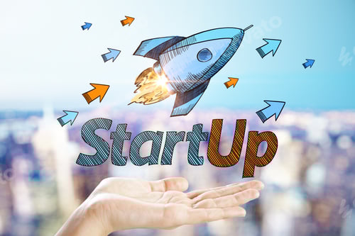 Preview: Hand Holding Creative Startup Rocket Sketch On Blurry City Background. Entrepreneurship And