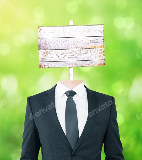 Preview: Young Businessman Body With Wooden Signboard Instead Of Head On Green Background. Mock Up