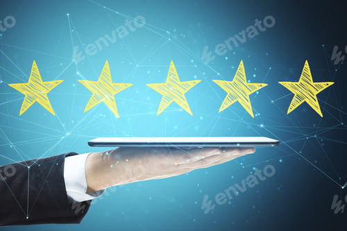 Preview: Hand Holding Digital Tablet With Yellow Star Rating On Blue Background. Evaluation And Assessment
