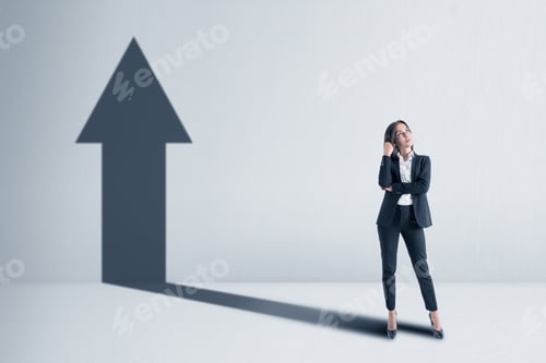 Preview: Businesswoman With A Shadow In The Shape Of An Arrow Up On The Blank White Concrete Wall
