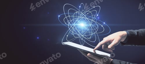 Preview: Close Up Of Businessman Hand Holding Pad With Abstract Glowing Atom Hologram On Dark Background