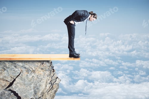 Preview: Risk And Danger Concept. Young Businessman Looking Down From Cliff. Sky Background