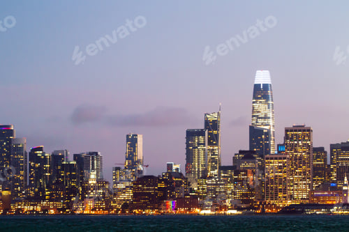 Preview: Modern Waterfront San Francisco City Skyline Backdrop With Illuminated Buildings At Dawn. Urban