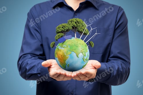 Preview: Close Up Of Male Hands Holding Creative Globe With Trees And Solar Panels On Blue Background