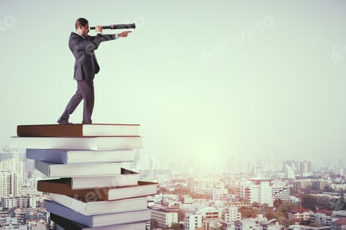 Preview: Side View Of Young Businessman With Binoculars Standing On Pile Of Books. Vision And Knowledge