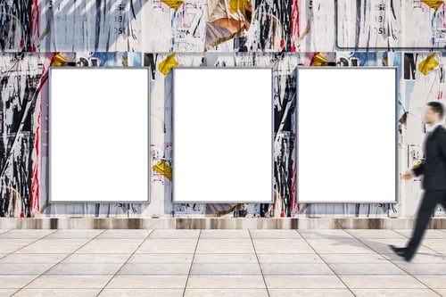 Preview: Businessman Walking Near Blank Three Billboards On Loft Style Wall. Performance And Presentation