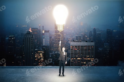 Preview: Businessman Holding Light Bulb On City Background. Success And Startup Concept.