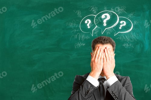 Preview: Young Businessman With Drawn Question Marks. Brainstorm And Faq Concept