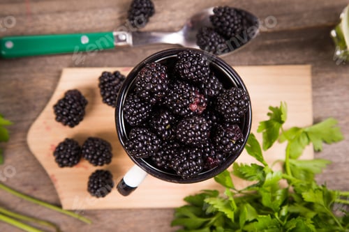Preview: Many Fresh Blackberry In White Metallic Old Cup With Lemon Water