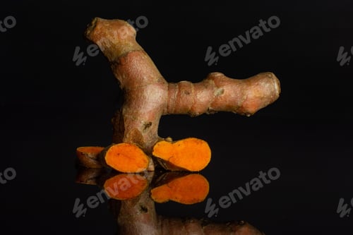 Preview: Group Of One Whole Three Slices Of Bright Turmeric Rhizome Isolated On Black Glass